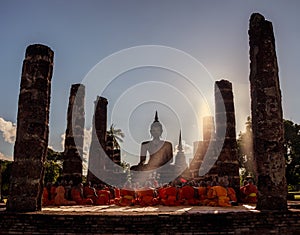 Buddhist monks are praying in front of Buddha image.