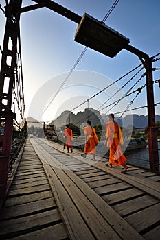Buddhist monks and rusty bridge