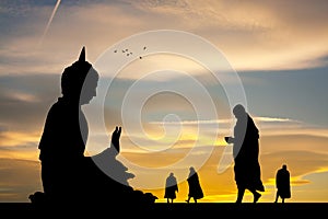 Buddhist monks at the temple at sunset