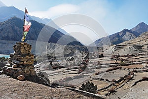 Buddhist monument with a flag and a view of the mountains