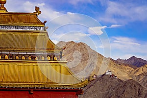 The Buddhist Namgyal Tsemo Gompa monastery seen from the golden temple roof at Shanti Stupa in Leh, India