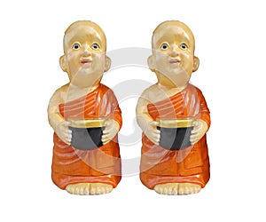 Buddhist novice resin characters holding alms bowl in hand isolated on white background
