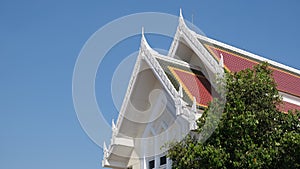 Buddhist pavilion roof soars into blue sky
