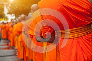 Buddhist philanthropy concept. Buddhist Monks line up in row photo