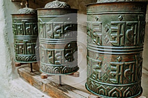 Buddhist prayer bronze drum close-up. Om padme hum. Asian symbol, religion.