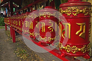 Buddhist prayer drums red and yellow, religious mantras
