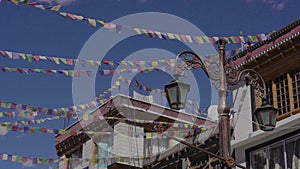 Buddhist prayer flags adorning the skies above Ladakh's markets, India