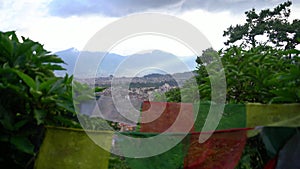 Buddhist prayer flags and the city view of Kathmandu, Nepal against the backdrop of mountains