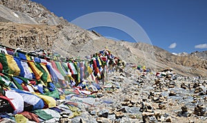Buddhist prayer flags and stone pyramids