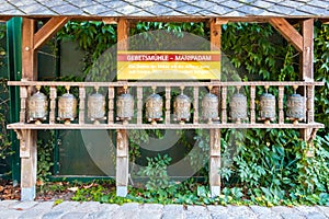 Buddhist prayer wheels, cylindrical rolls on a spindle made from metal and wood