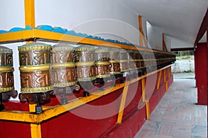 Buddhist Prayer Wheels lord buddha with Sanskrit writing with mantra Om Mani Padme Hum