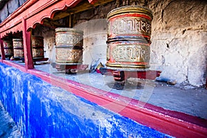 Buddhist prayer wheels in Tibetan monastery with written mantra. India, Himalaya, Ladakh