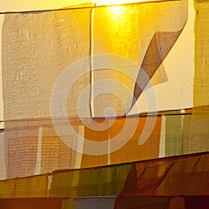 Buddhist praying flags at the sunset