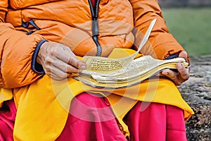 A Buddhist reading ancient scrolls in Sarnath where Gautama Buddha first taught the Dharma. photo