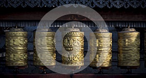 Buddhist shiny prayer wheels rotating in motion