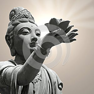 Buddhist statue holding lotus flower