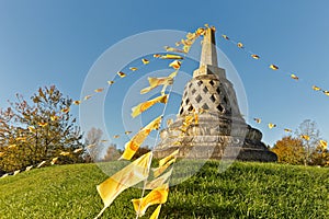 Buddhist stupa on a hill decorated with Buddhist prayer flags, E