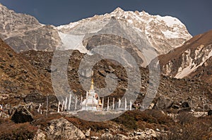 Buddhist stupa near Village of Kyangjin Gompa with Langtang lirung on background