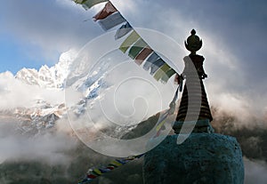 Buddhist Stupa with prayer flags and Thamserku peak - Nepal