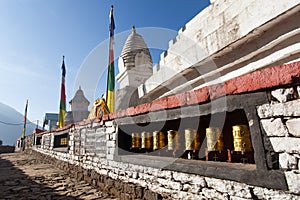Buddhist stupa with prayer flags and wheels Khumbu