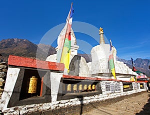 Buddhist stupa with prayer flags and wheels Khumbu