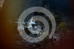 Buddhist stupa seen through prayer flags in Chame