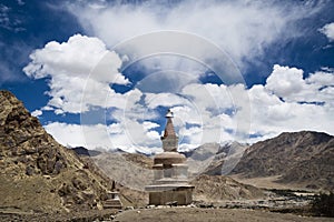 Buddhist stupa surrounded by mountains in Ladakh