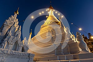 Buddhist stupas illuminated at dusk