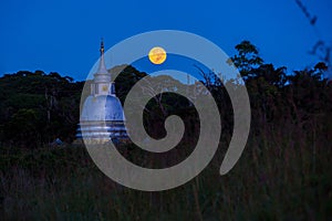 Buddhist temple and full moon