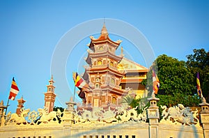 Buddhist temple and pagoda Buu Son lit by sunset. Vietnam