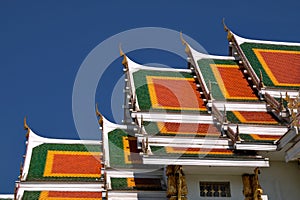 Buddhist temple`s roofs soar into blue sky