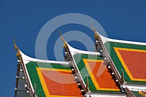 Buddhist temple`s roofs soar into blue sky