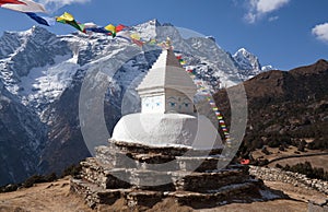 Buddhist white stupa with prayer flags in Nepal Himalaya