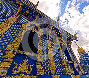 Buddhist wooden structure with gold ornamentation Wat Rong Suea Ten Blue Temple at Chiang Rai Thailand