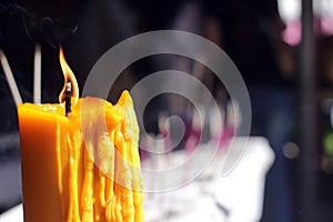 Buddhists make merit,Placing a lighted candle and lit incense with candles frame at temple. Selective focus