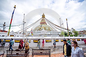 Buddhists praying at the great Boudhanath Stupa in Kathmandu, Nepal on a cloudy day