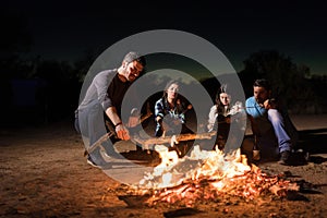 Buddies Near The Bonfire While Camping