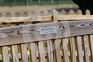 A buddy bench where friends or strangers can sit for a conversation and companionship. Friendship, loneliness, mental health