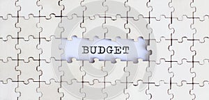BUDGET .Business concept. White puzzle pieces with different phrases on the white background, top view