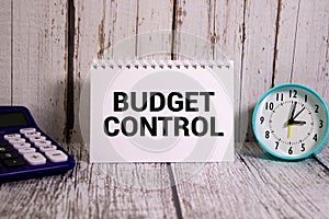 Budget Control. Burning sheet of paper with text on a rusty metal background