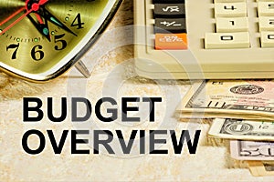 Budget overview. the inscription on the background of the calculator and cash.