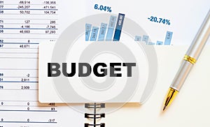 BUDGET word on white notepad with pen and accounting numbers