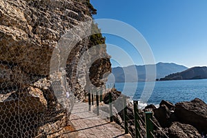 Budva - Idyllic walk along steep high cliffs to the central beach Mogren of coastal tourist city of Budva, Montenegro