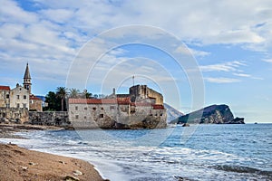 Budva, Montenegro. Beach near old town wall and fortress in wint