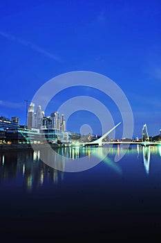 Buenos Aires Puerto Madero modern city with skyscrapers at night and Darcena Puente de la Mujer photo