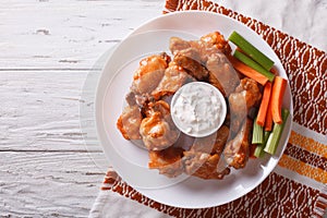 Buffalo chicken wings with sauce and celery.horizontal top view