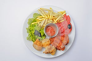 Buffalo chicken wings with tomato dip sauce. Served on a white plate over white background