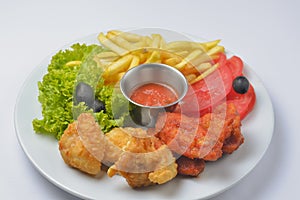 Buffalo chicken wings with tomato dip sauce. Served on a white plate over white background