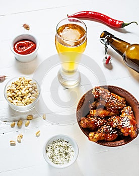 Buffalo style chicken wings served with cold beer