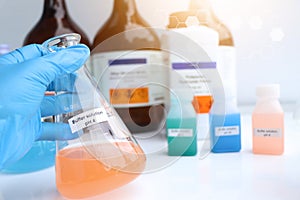 Buffer solution in glass, chemical in the laboratory and industry